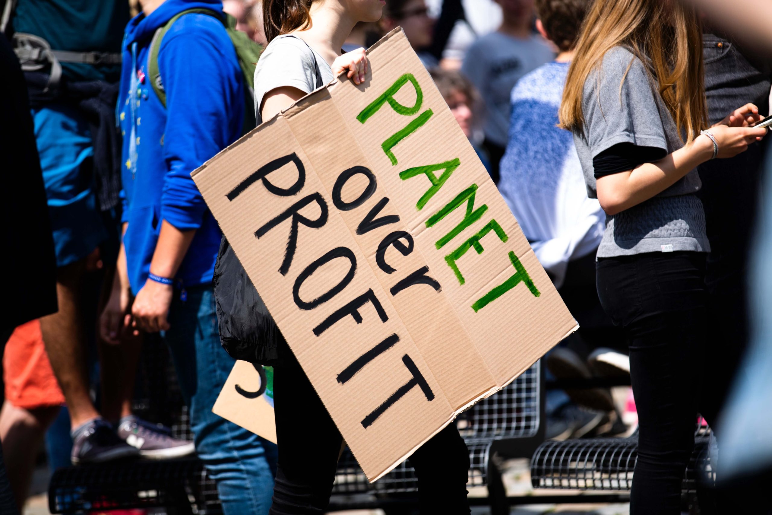 A poster bearing the words 'planet over profit'